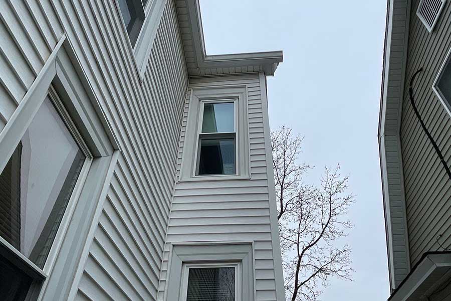 New construction windows installed on a vinyl siding home with new white window frames in Springfield, IL.