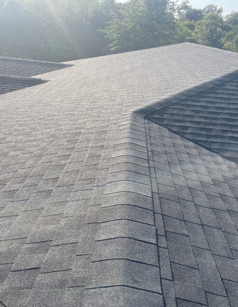 This is a picture of a newly installed GAF roof by Sutton's with sunlight beaming on it.