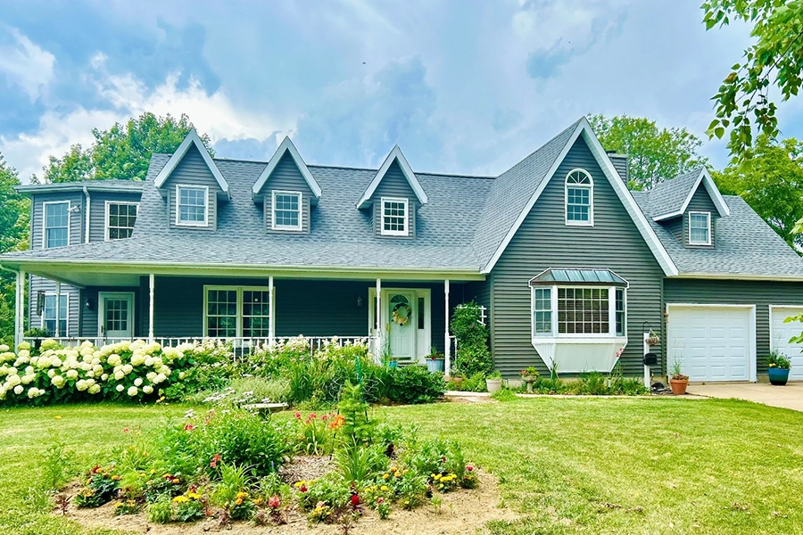 A house in Chatham, IL, outside of Springfield, IL, with new roofing and siding installed by Sutton's Inc. from Springfield, IL.