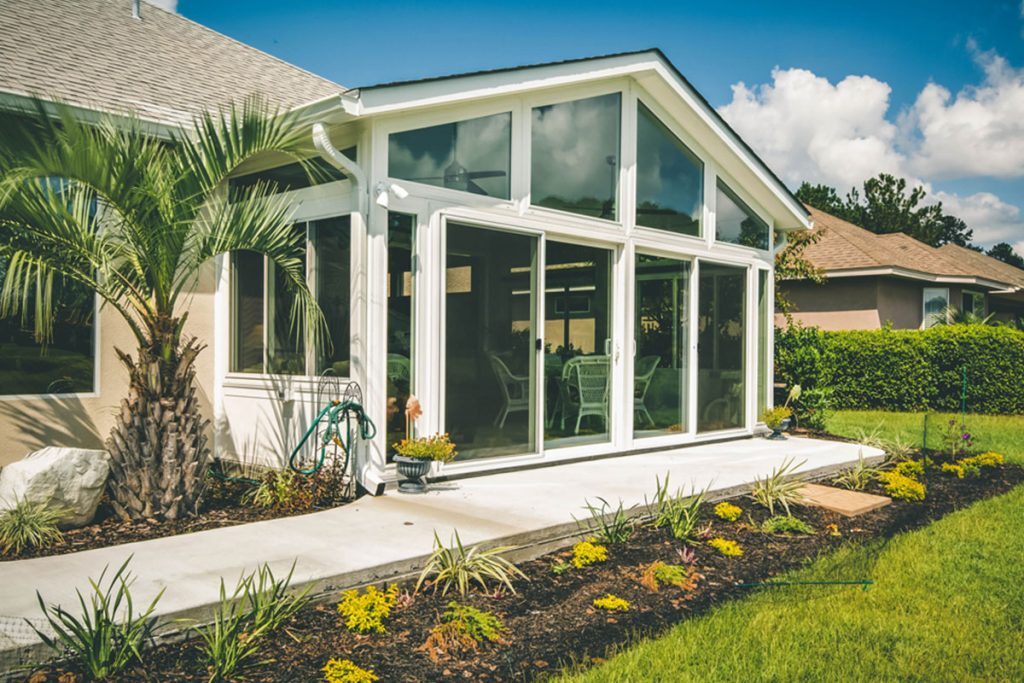 Living Space Sunrooms promo showing a sunroom addition attached to the back of a home – available from Sutton’s in Springfield IL