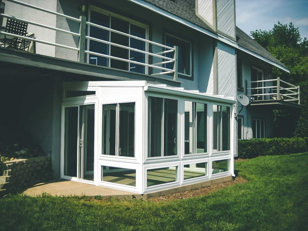 Living Space Sunrooms promo showing a lower-level sunroom built beneath a deck – available from Sutton’s in Springfield IL