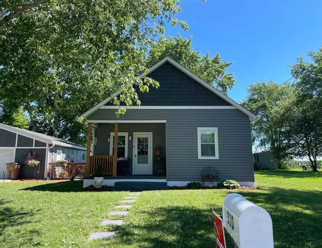Single-story home featuring blue-gray shake siding in the gable and horizontal siding below with white trim, installed by Sutton’s in Springfield IL