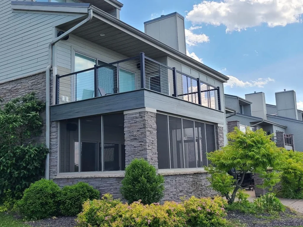 Screenroom finished by Sutton’s on a Lake Springfield townhome with a composite deck and designer railings above